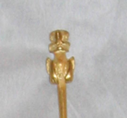 detail of figure at tip of lime dipper