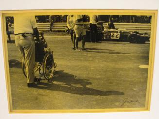 Untitled (boy in wheelchair photographing racing car, Elkhart Lake, WI)