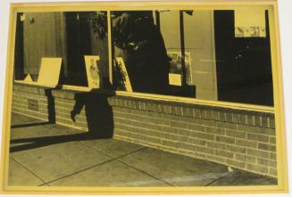 Untitled (man in store window with hands behind his back, DC)