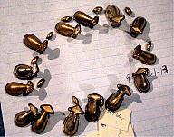 Set of Fourteen Frog Effigy Rattle Beads