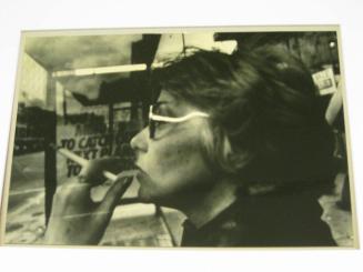 Untitled (woman in bus shelter with cigarettes and glasses, DC)