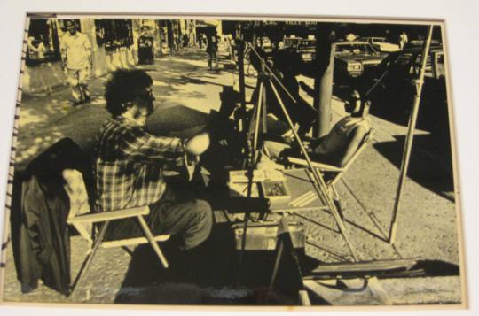 Untitled (man drawing portrait of person with shadows, Montreal)