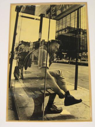 Untitled (man smoking, peering up from bus shelter, DC)