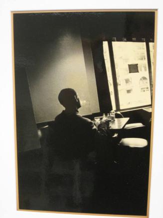Untitled (man exhaling last puff of cigarette in cafeteria, Hotel Harrington, DC)