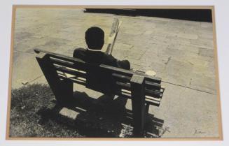 Untitled (man on bench looking at folded newspaper, DC)