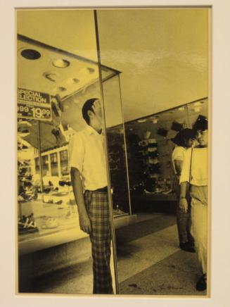 Untitled (man with hand across face in  mirrored store front, DC)