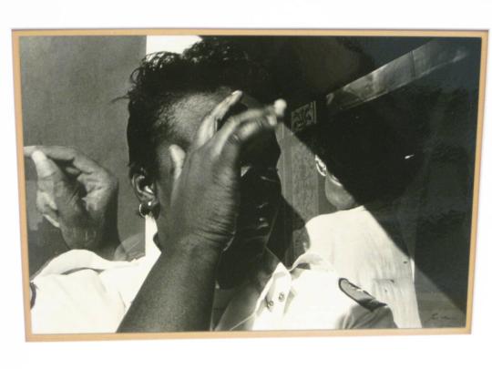 Untitled (uniformed woman in bus shelter with hand to head, DC)