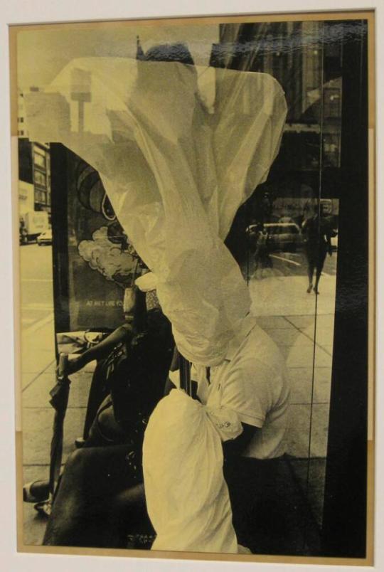 Untitled (woman with white bag over head in bus shelter, DC)