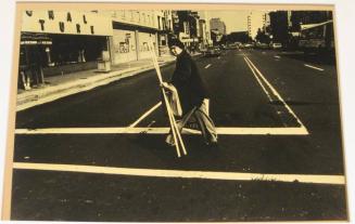 Untitled (woman with white sticks, white street lines, DC)