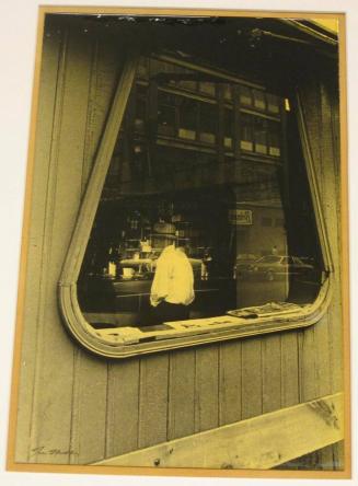 Untitled (man with cup of coffee in cafe window)