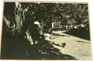 Untitled (man and woman on bench with feet up, DC)