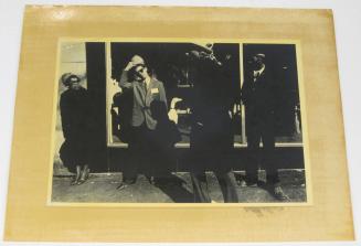 Untitled (four people in front of store window, glass dog in window, DC)