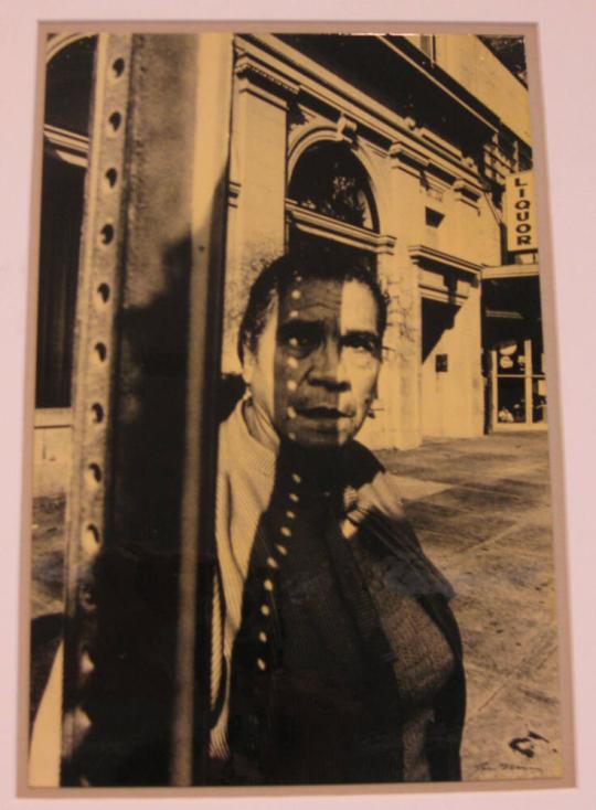 Untitled (woman in shadow of bus stop sign, dots across face, DC)