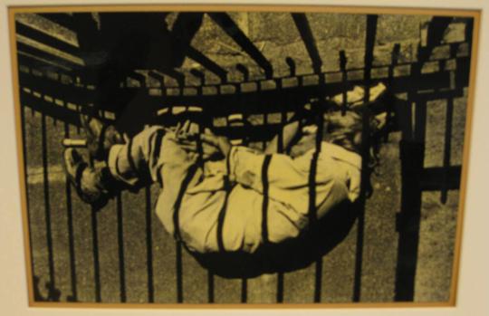 Untitled (man lying in fence shadow, DC)