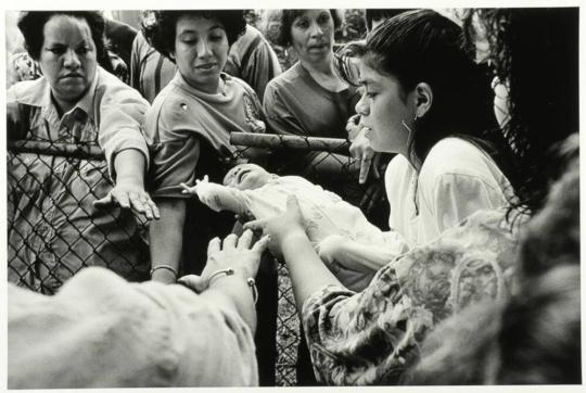 Girl Holds Child Out for Healing...