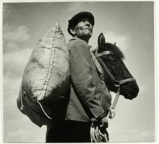 Peasant from the village of Iagoda with full bag of wheat grass