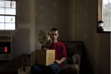 Tylor holding his father's ashes, Carbondale, Ohio