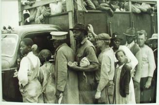 Vegetable workers, migrants, waiting after work to be paid. Near Homestead, Florida