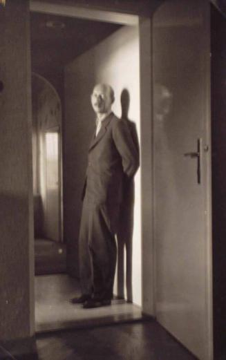 Untitled (man standing in doorway)