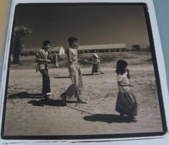 Girl leading blind father and his friend - 1993, Cambodia