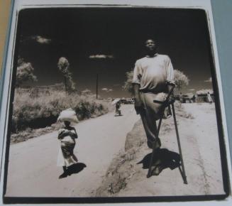 Chim Chanthorn with his Daughter in the background - 1993, Cambodia