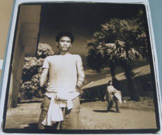 Nen Mab with protection tattoos on arms, injured removing a mine - 1993, Cambodia