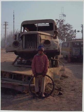 Jawad, who like many Afghans uses just the one name, out playing with an old tyre in the Mikrorayon district of Kabul.