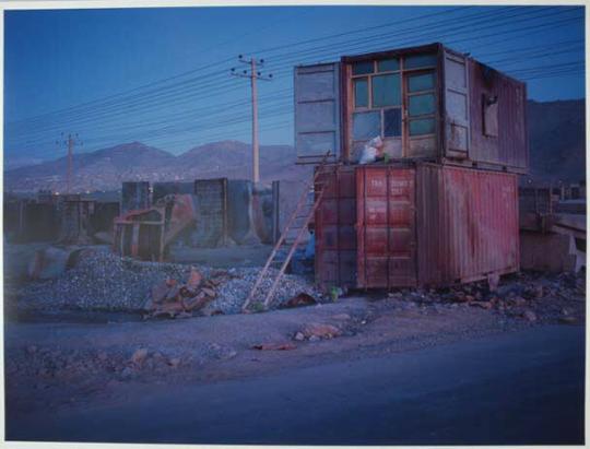 On the very northern edge of Kabul. A shipping container is re-purposed as home to men working in a yard casting concrete blast walls. Each section, when sold to foreign embassies or the military, fetches $1000 per piece.