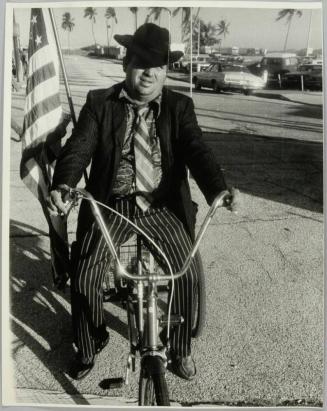 [Man on Bicycle with American Flag]