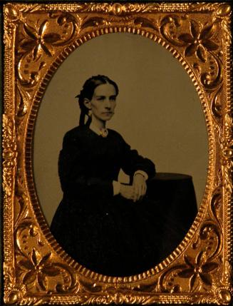 [Seated female, facing right]