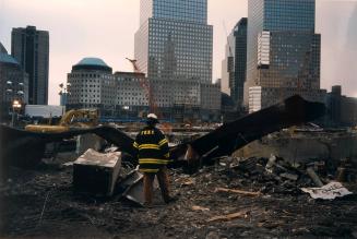 A fireman examining rubble