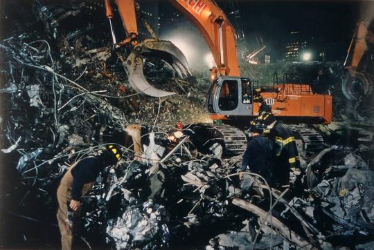 Firemen searching through the debris dropped by a grappler