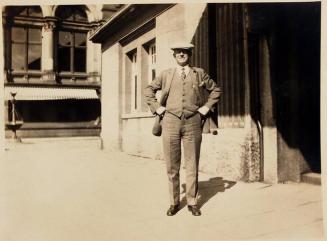 [man in suit in front of building "Harry / Phil / SUNDAY 8AM / April 1928"]