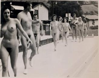 [nude men and women walking in a line "THE NUDIST CREDO..."]