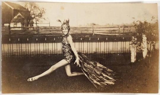 [woman in yard wearing bird costume]