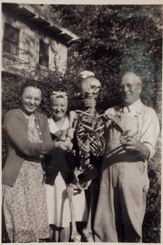 [two women and a man with skeleton]