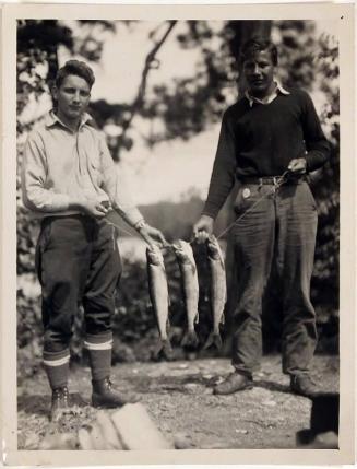 [two men with three caught fish]