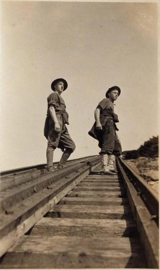 [two men in uniform on railroad track "1921"]