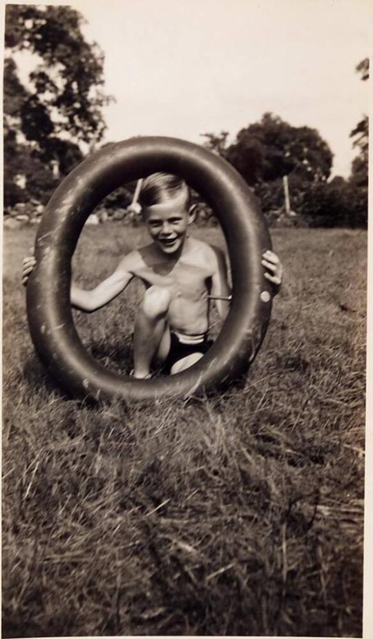 [boy with innertube on lawn]