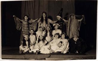 [14 children on stage in costumes]