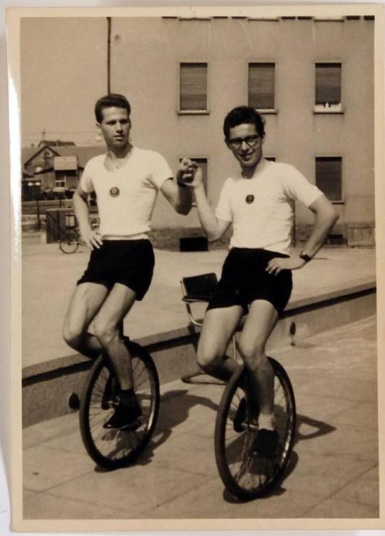 [two men on unicycles]