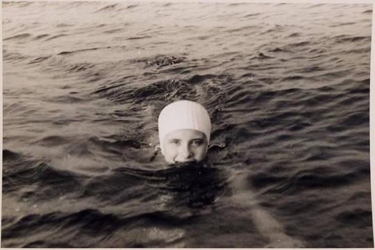 [person in swimming cap in water]