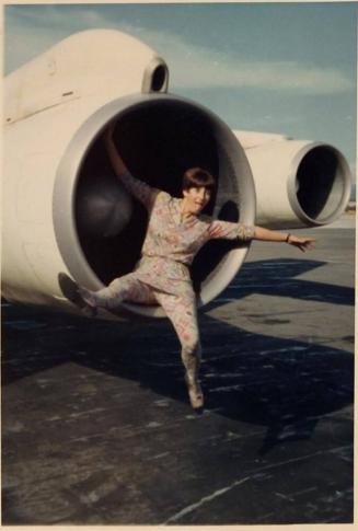 [woman sitting in jet engine "NOV 68"]