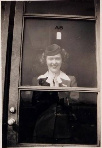[woman in unifrom viewed through glass door "Rita- / Wash. Operations / Spring 1947"