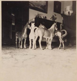 [four model horses viewed from rug]