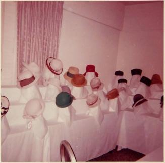 [display of hats on tiered tables]