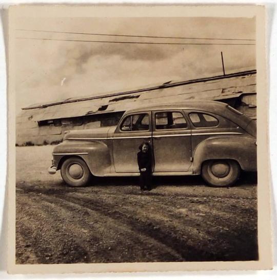 [child in front of car]