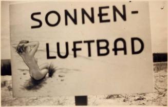 [sign on beach with image of nude woman on beach  "SONNEN- / LUFTBAD"]