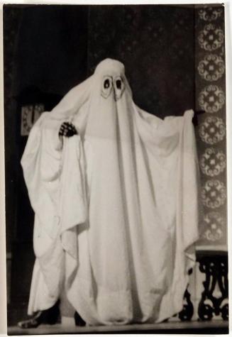 [person dressed as ghost with sheet  and eye holes cut out]