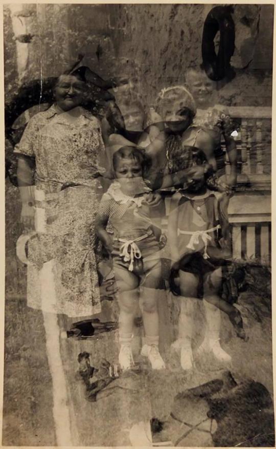 [double exposure. vertical- woman and children standing; horizontal- adults and children at beach]